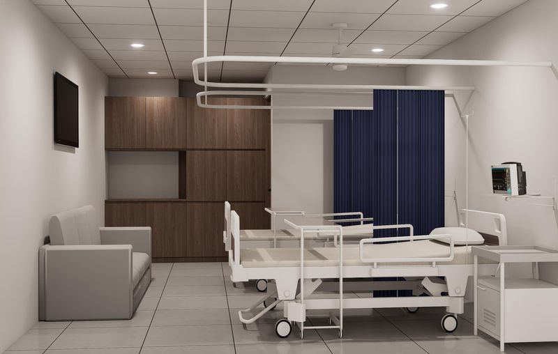 Patient room with hospital bed, monitor and attendant sofa