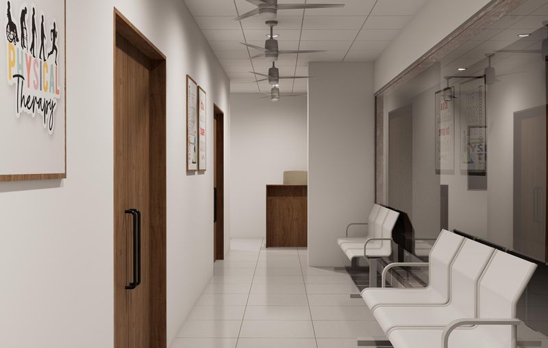 Patient waiting area with seating along a well-lit corridor